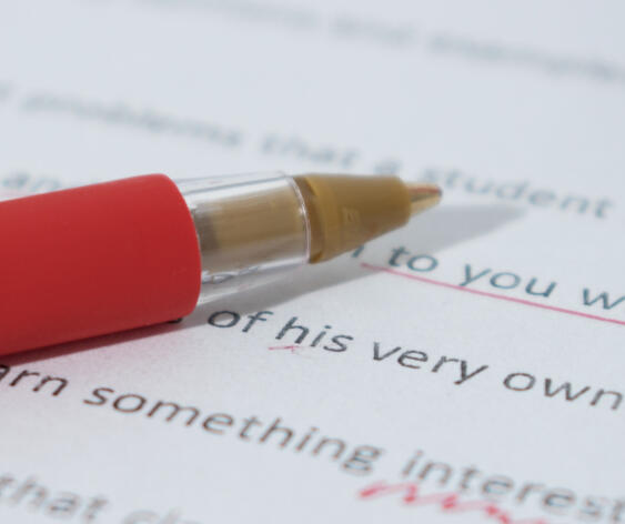 Line Edits Red on a page of work with underlines, and marked up edits.