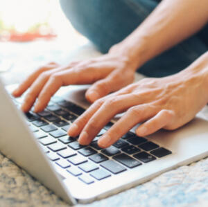 Proof Reading Edits Someone typing on their lap top doing proof reading edits